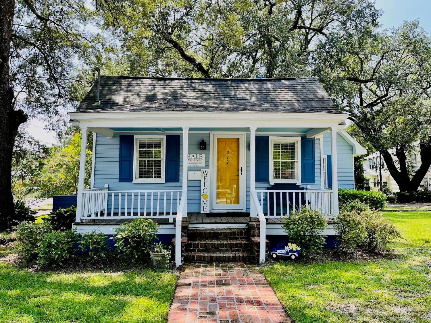 Restored blue historic cottage with a full front porch and period shutters, a completed Hale Development renovation in Summerville, SC
